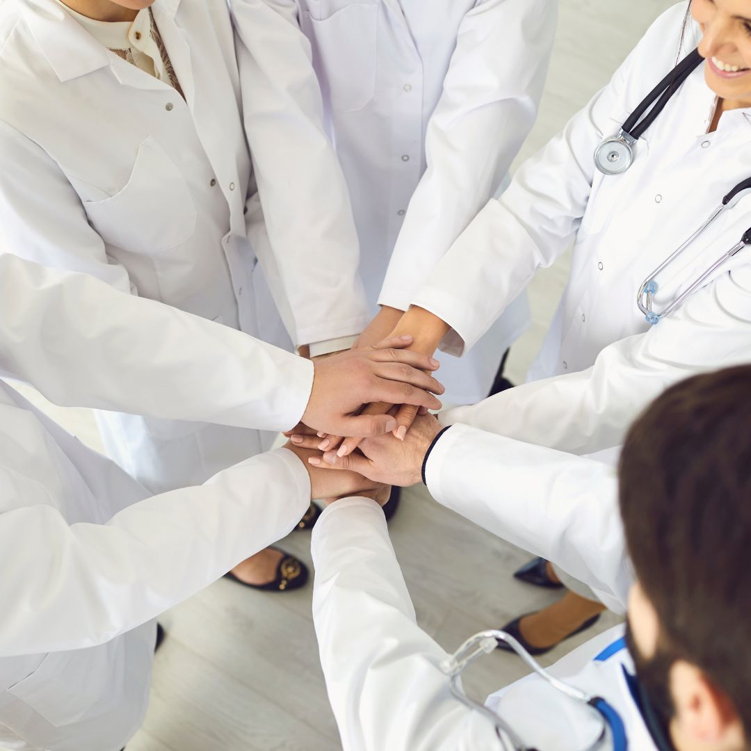 Image of a team with their hands together.