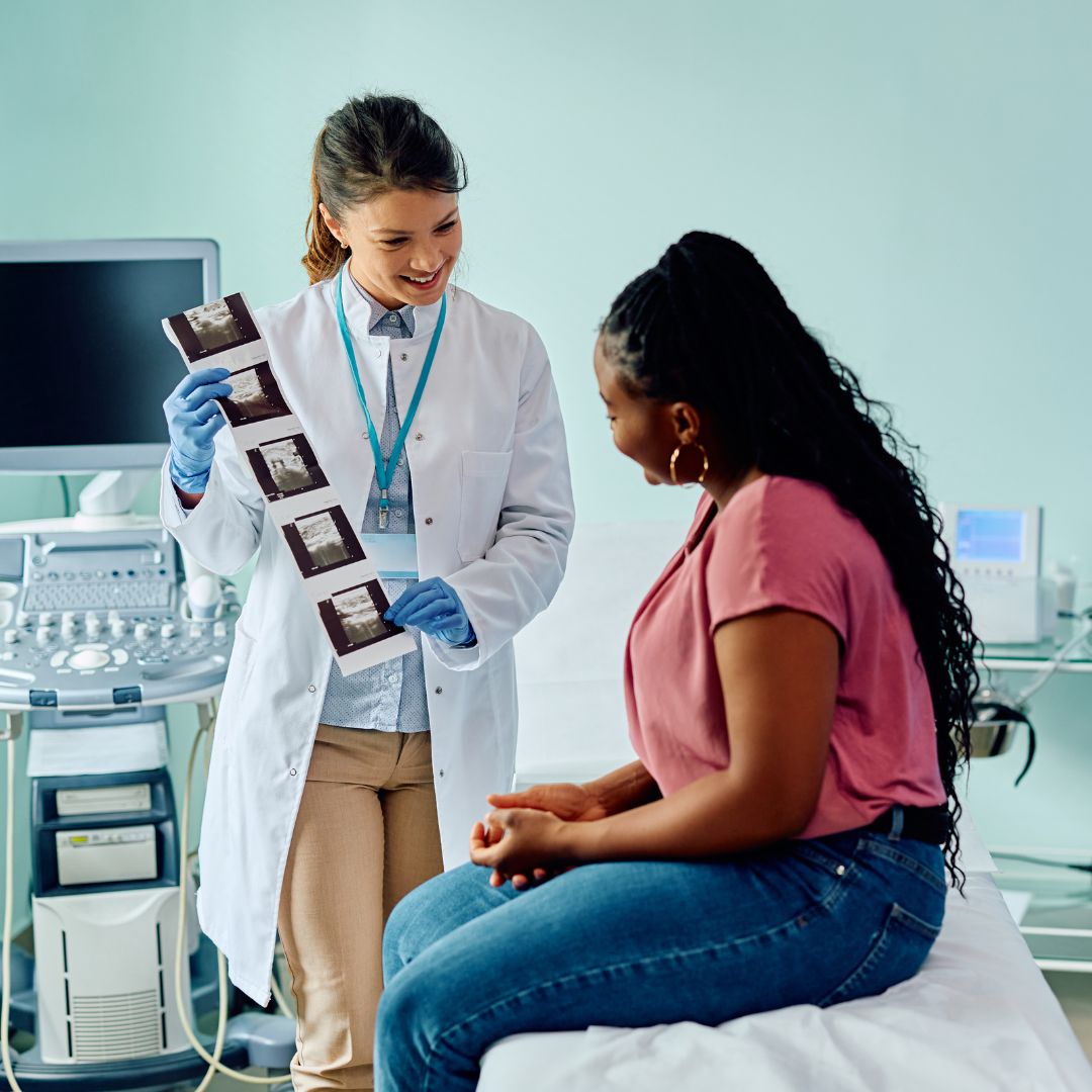 Image of a happy patient receiving clear billing information from a friendly staff member